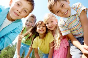 Young children standing in a field.